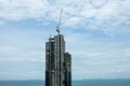 Crane build a building on the beach in front of sea Royalty Free Stock Photo