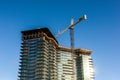 Crane and building construction with clear blue sky