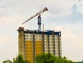 Crane at building construction with cloudy sky as background photo taken in Depok Indonesia