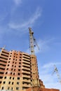 Crane and building construction site against blue sky Royalty Free Stock Photo