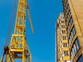 Crane and building construction site against blue sky Royalty Free Stock Photo