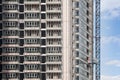 Crane and building under construction against blue sky. Royalty Free Stock Photo