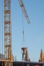 Crane work. Crane on the construction lowered the concrete to workers. Royalty Free Stock Photo