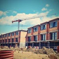 Crane and construction of new buildings. Beautiful background for the construction industry at sunset. Royalty Free Stock Photo