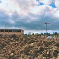 Crane and construction of new buildings. Beautiful background for the construction industry at sunset. Royalty Free Stock Photo