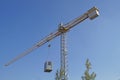 Crane at a construction site with container suspended