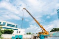 Crane at a construction site lifting materials against a clear sky Royalty Free Stock Photo