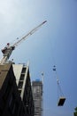 Crane on construction site lifts materials