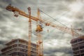 Crane on construction site near concrete buildings. Concept of construction close-up Royalty Free Stock Photo