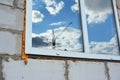 Crane construction in window mirror reflection on unfinished building house construction Royalty Free Stock Photo