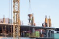 Construction of a multistory building. workers pour concrete into the formwork.