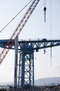 Crane detail on construction building site lifting freight containers Royalty Free Stock Photo