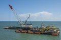 Crane on dredging platform outside Port Canaveral, Florida, USA