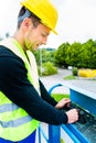 Crane driver driving hydraulic lifting ramp with control desk Royalty Free Stock Photo