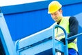 Crane driver driving hydraulic lifting ramp with control desk Royalty Free Stock Photo