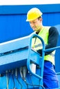 Crane driver driving hydraulic lifting ramp with control desk Royalty Free Stock Photo