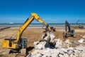 crane or excavator equipped with a grapple handling large rocks Royalty Free Stock Photo