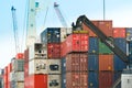 Crane fork loading cargo ship witth containers at the Port of Iquique