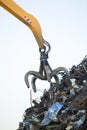 Crane grabber loading metal rusty scrap