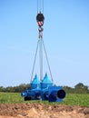 Crane handling 500mm pipe with gate valves. Construction process Royalty Free Stock Photo