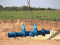 Crane handling 500mm pipe with gate valves. Construction process Royalty Free Stock Photo