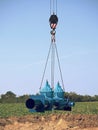 Crane handling 500mm pipe with gate valves. Construction process Royalty Free Stock Photo