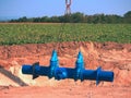 Crane handling 500mm pipe with gate valves. Construction process Royalty Free Stock Photo