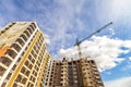 Crane and high rise building under construction against blue sky Royalty Free Stock Photo