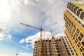 Crane and high rise building under construction against blue sky Royalty Free Stock Photo