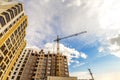 Crane and high rise building under construction against blue sky Royalty Free Stock Photo