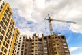 Crane and high rise building under construction against blue sky Royalty Free Stock Photo