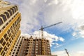 Crane and high rise building under construction against blue sky Royalty Free Stock Photo