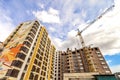 Crane and high rise building under construction against blue sky Royalty Free Stock Photo