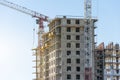 Crane and high-rise residential building. Real Estate Construction Royalty Free Stock Photo