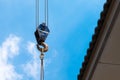 Crane Hook lifting  for construction on blue sky,steel hook and chain, copy space Royalty Free Stock Photo