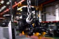 Crane hook of the overhead crane in the workshop of an industrial plant for the production of tractors and agricultural harvesters