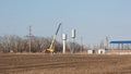 A crane installs a water tower.