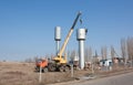 A crane installs a water tower.