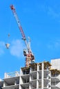 Crane lifting cement mixing container Royalty Free Stock Photo