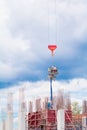 Crane lifting concrete mixer container and worker in construction building site workplace. on sky background with copy space add Royalty Free Stock Photo