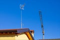 Crane for building lifting above the roof of the houses with antenna for the reception of television programs.