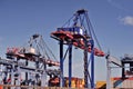 Crane lifting heavy cargo into a container at a busy port, symbolizing global and international trade Royalty Free Stock Photo