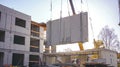 Crane Lifting Large Prefabricated Concrete Panel on Construction Site Modern Building Construction, Engineering, Heavy Royalty Free Stock Photo