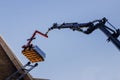 Crane lifting materials roofing construction at work Royalty Free Stock Photo