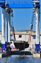 Crane lifts a boat Royalty Free Stock Photo