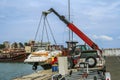 Crane lifts a boat Royalty Free Stock Photo