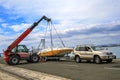 Crane lifts a boat Royalty Free Stock Photo