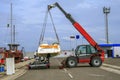 Crane lifts a boat Royalty Free Stock Photo