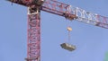 The crane lifts and drags the load