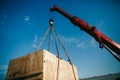 Crane lifts heavy container on a truck Royalty Free Stock Photo